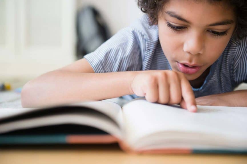 boy-reading-book-desk