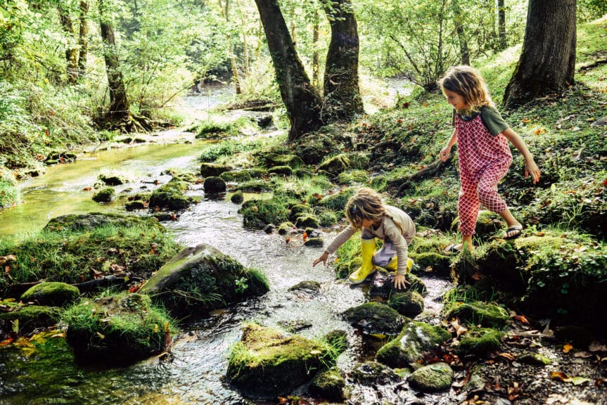 climbing-and-stepping-in-a-river-exploring-a-beautiful-natural-area