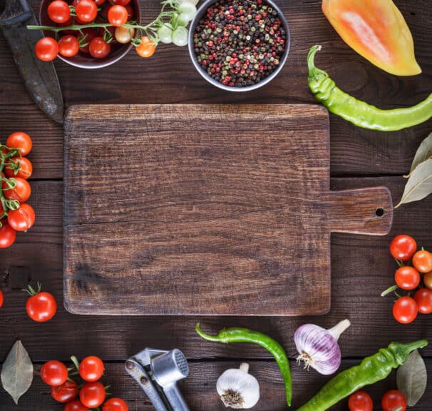 Directly-Above-Shot-Of-Cutting-Board-Amidst-Various-Ingredients-On-Table