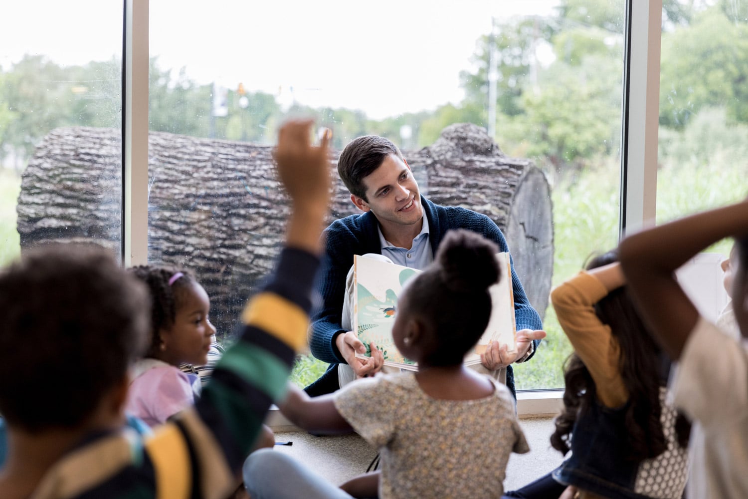 Ministry volunteer reads to a group of kids.