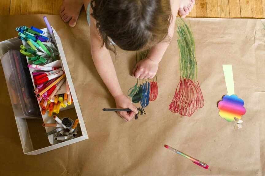 young girl coloring flowers