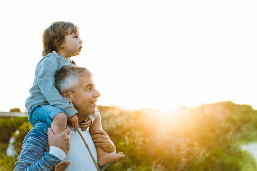 young boy on grandfather's shoulders