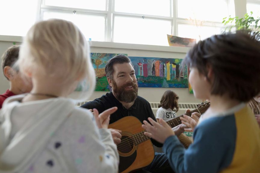 teacher with guitar school