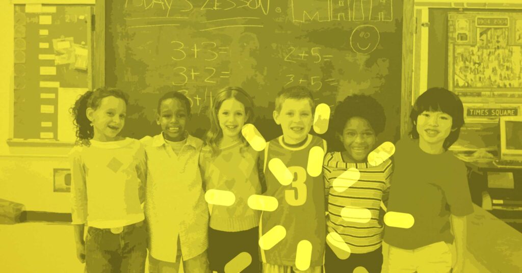 children standing arm in arm at front of class