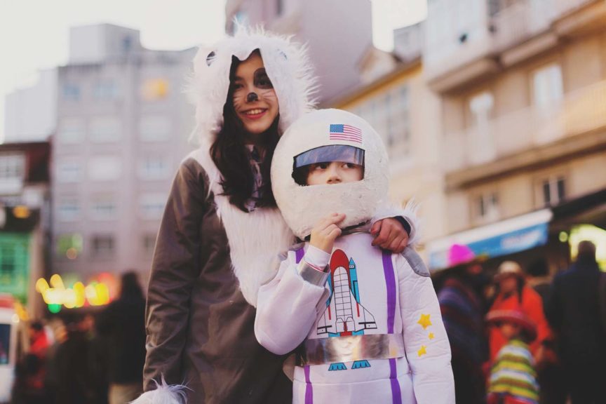 Two kids dressed up in halloween costumes as Astronaut and wolf