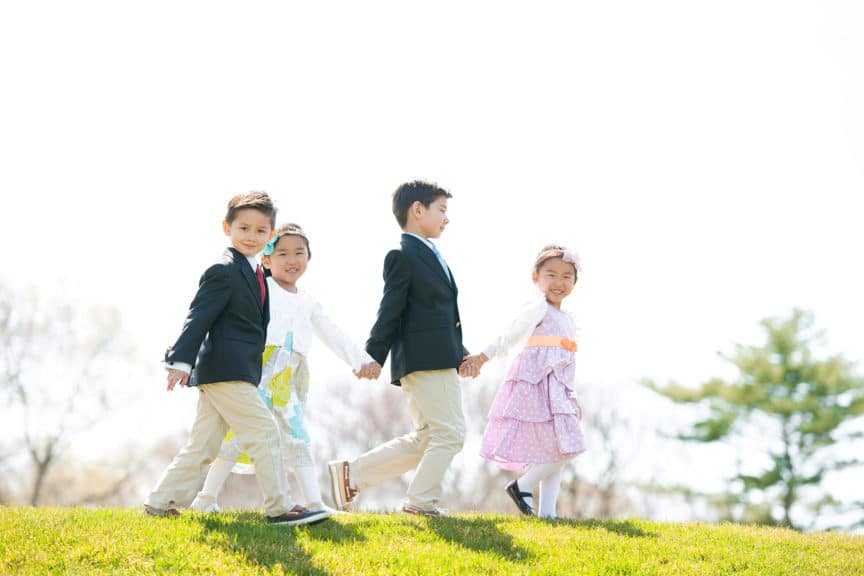 Kids walking hand in hand Easter clothing