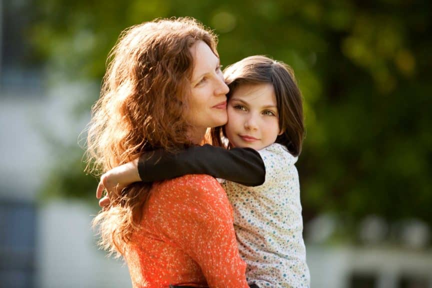Side view of mother carrying daughter
