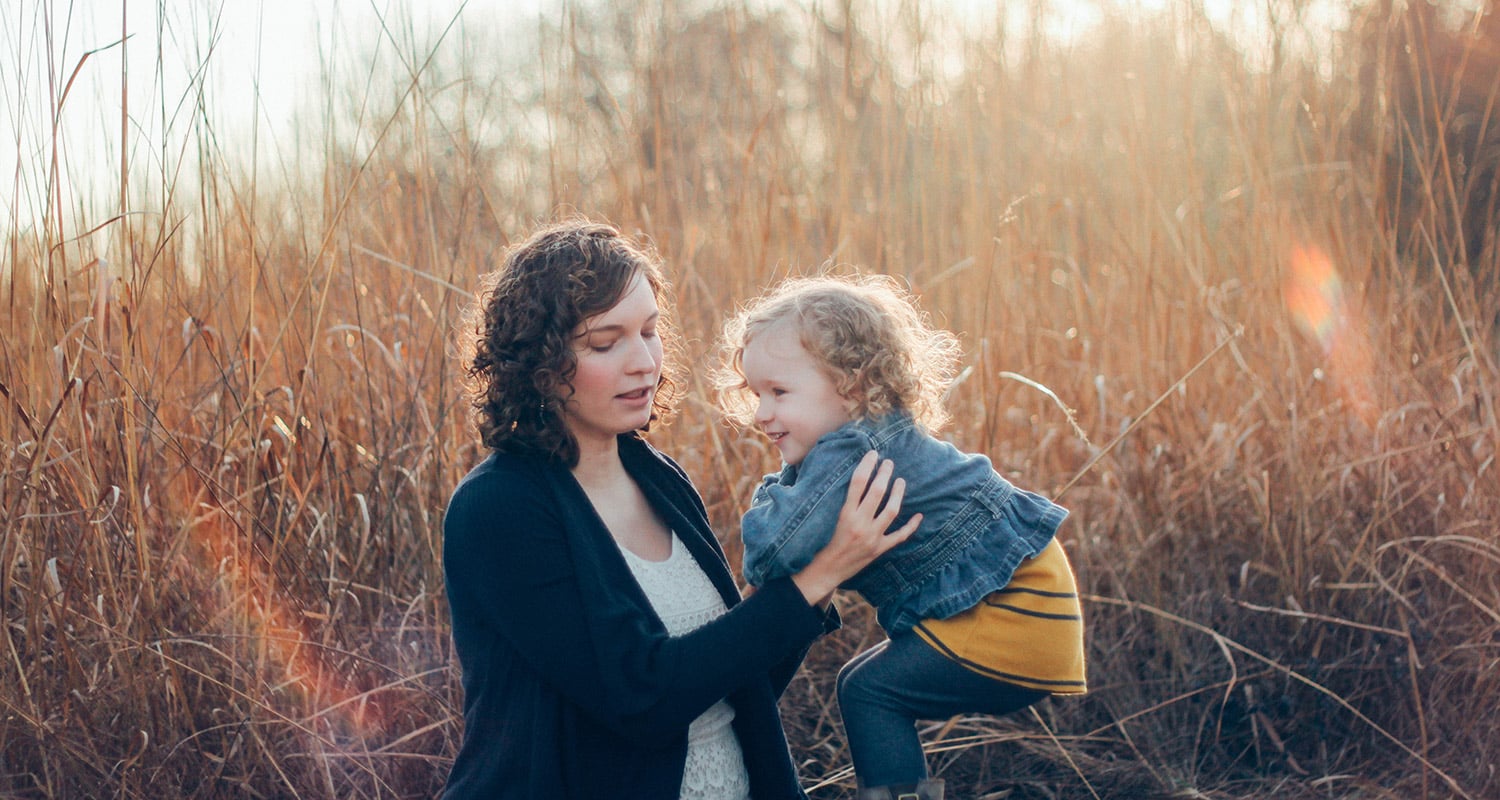 A children's ministry staff member plays with a young child.