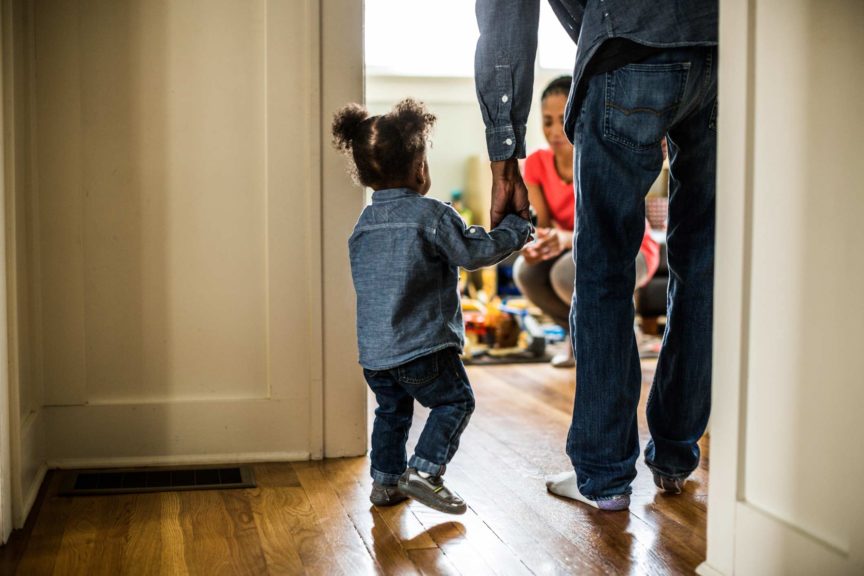 toddler and dad walking towards mother