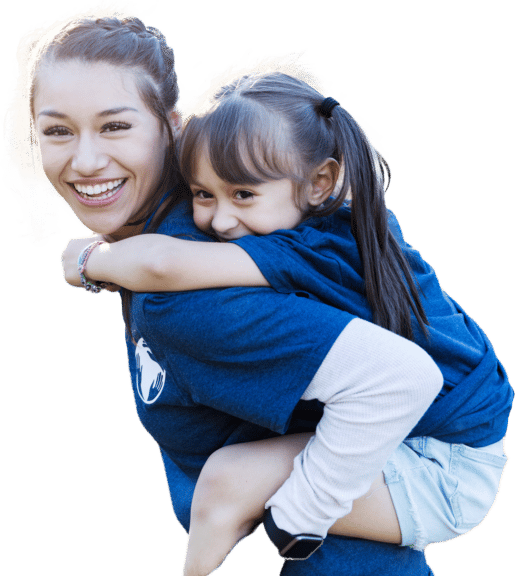 Children's Ministry counselor giving child a piggy back ride
